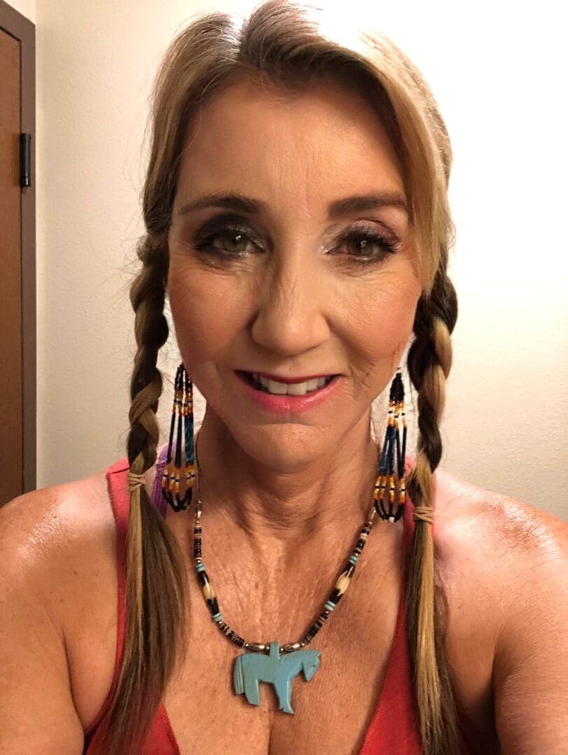 A woman with long braids and jewelry in her hair.