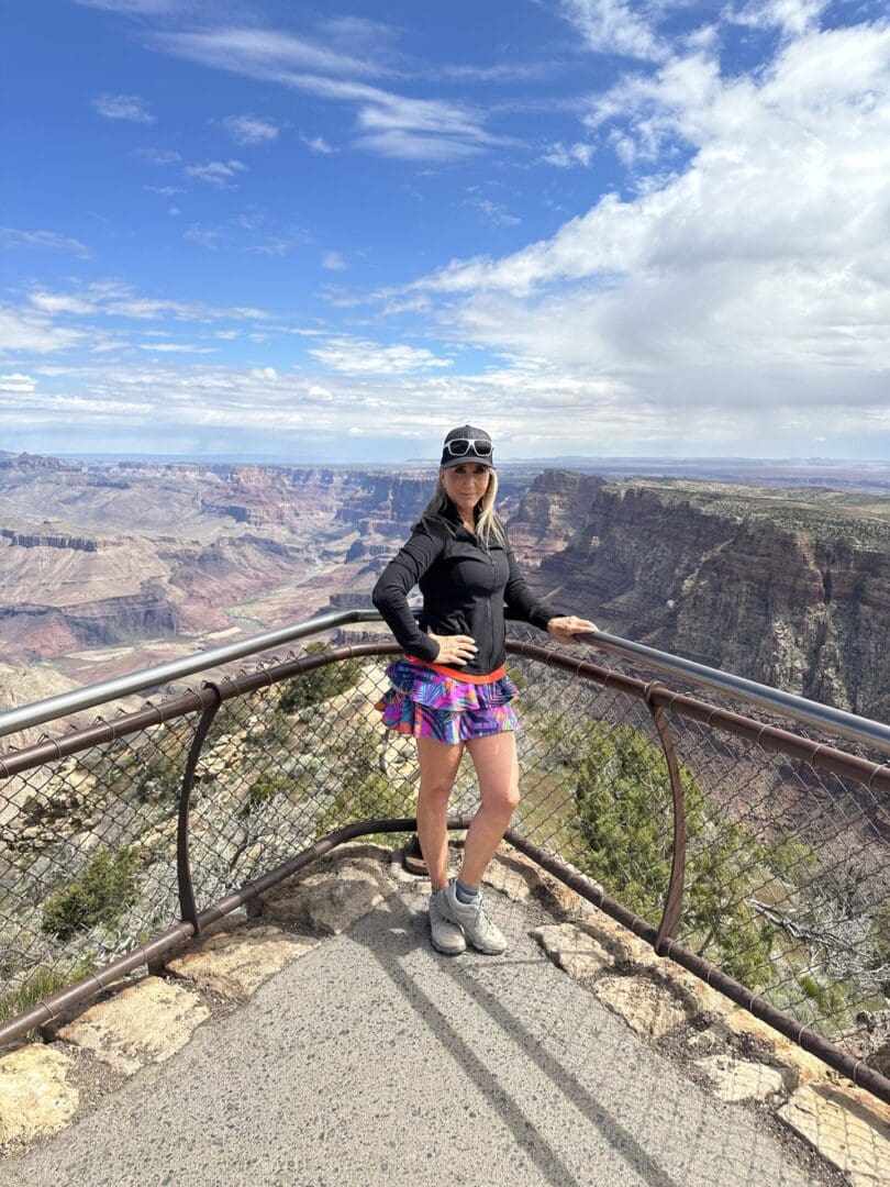 A woman standing on top of a wooden railing.