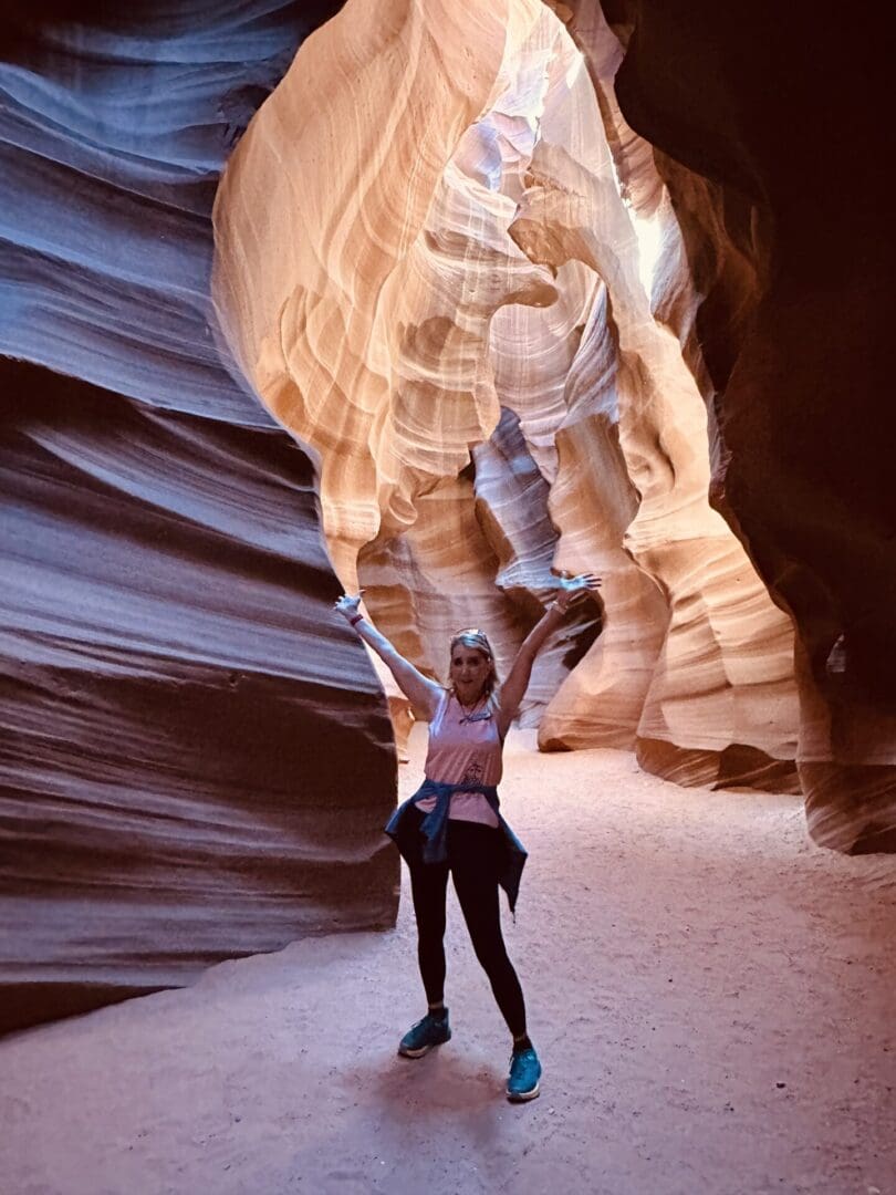 A woman standing in the middle of a cave.