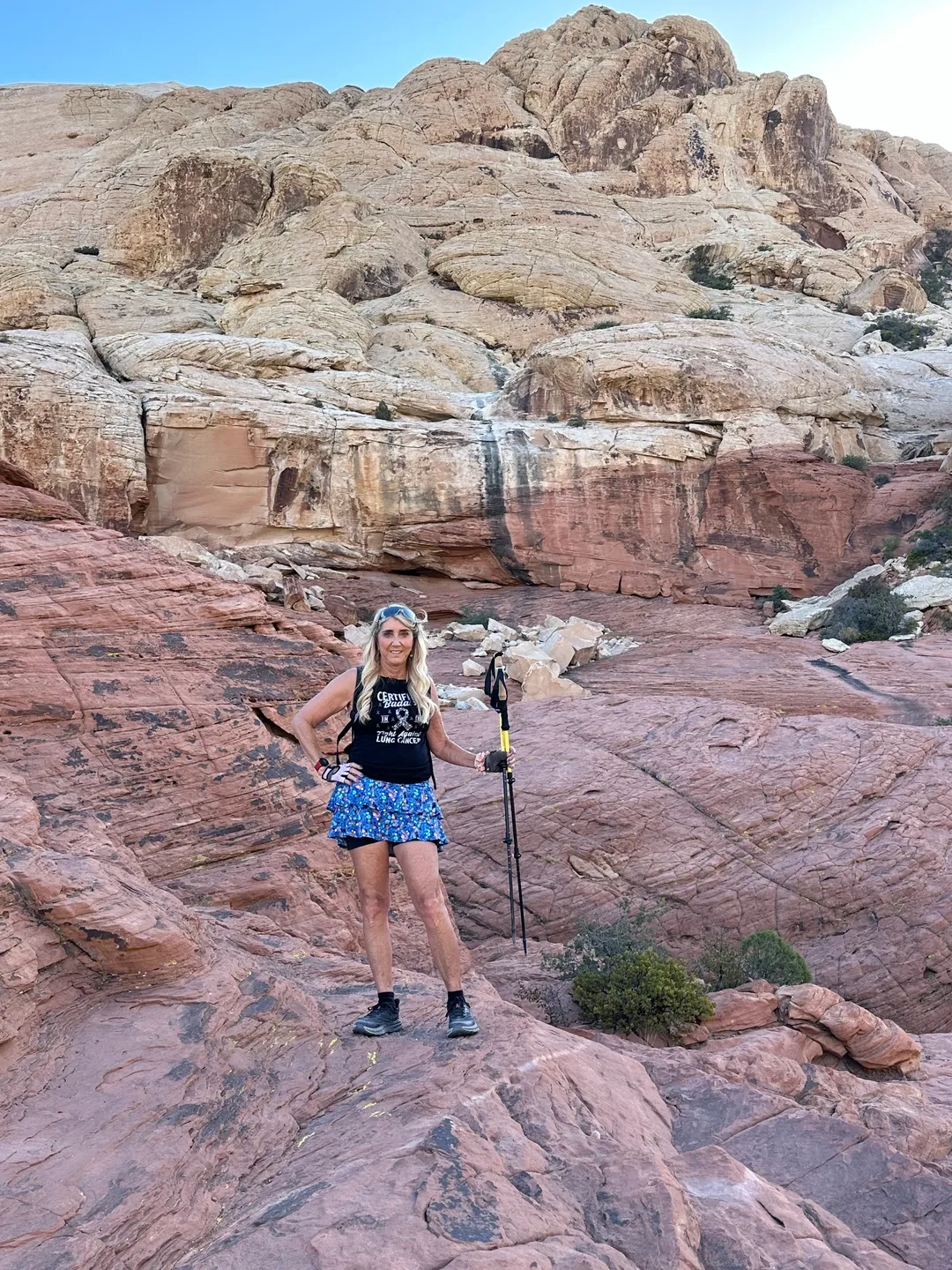 A woman standing on top of a rock formation.