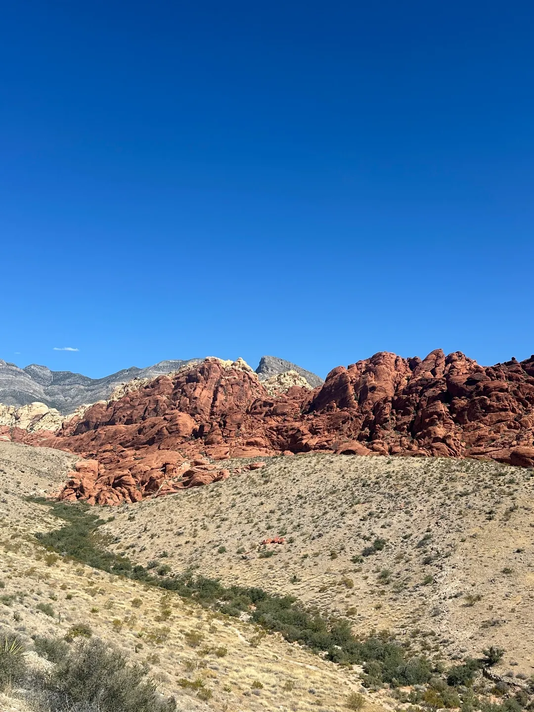 A view of some mountains and rocks in the desert.