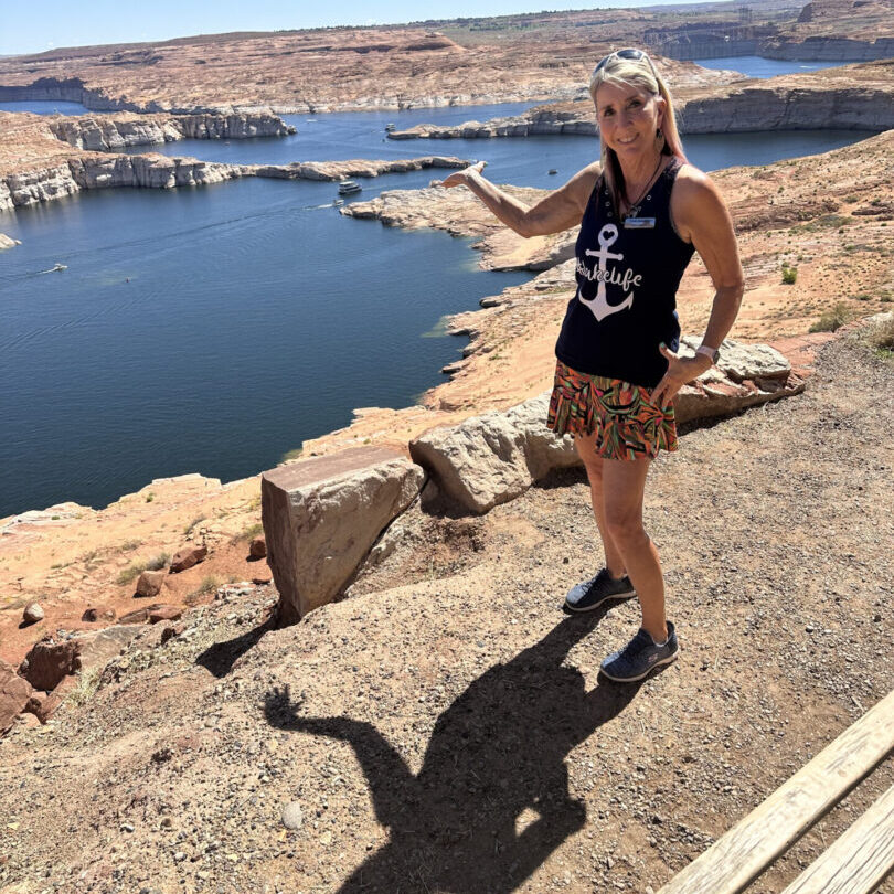 A woman standing on the side of a cliff.